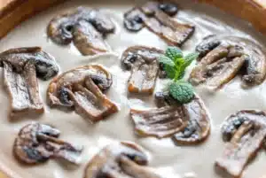 Creamy mushroom soup with fresh mint garnish, a Kacks Cafe lunch favorite.