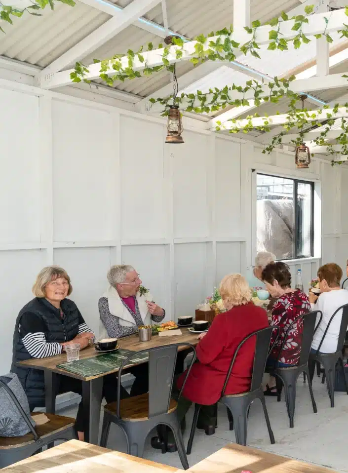 Relaxed cafe interior with patrons enjoying coffee and food at Kacks Cafe in Clevedon.