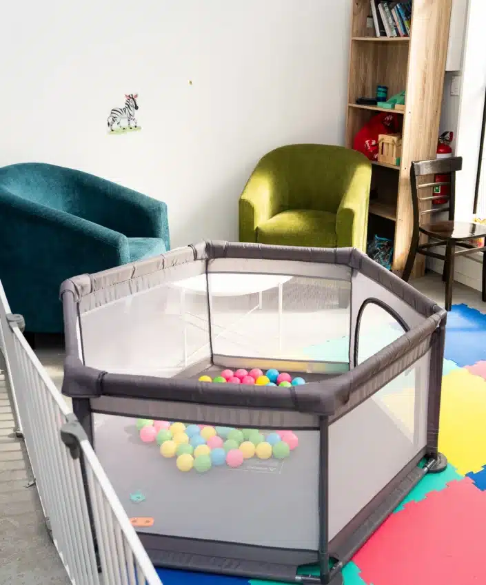Relaxed cafe interior with comfortable seating and a children's play area.